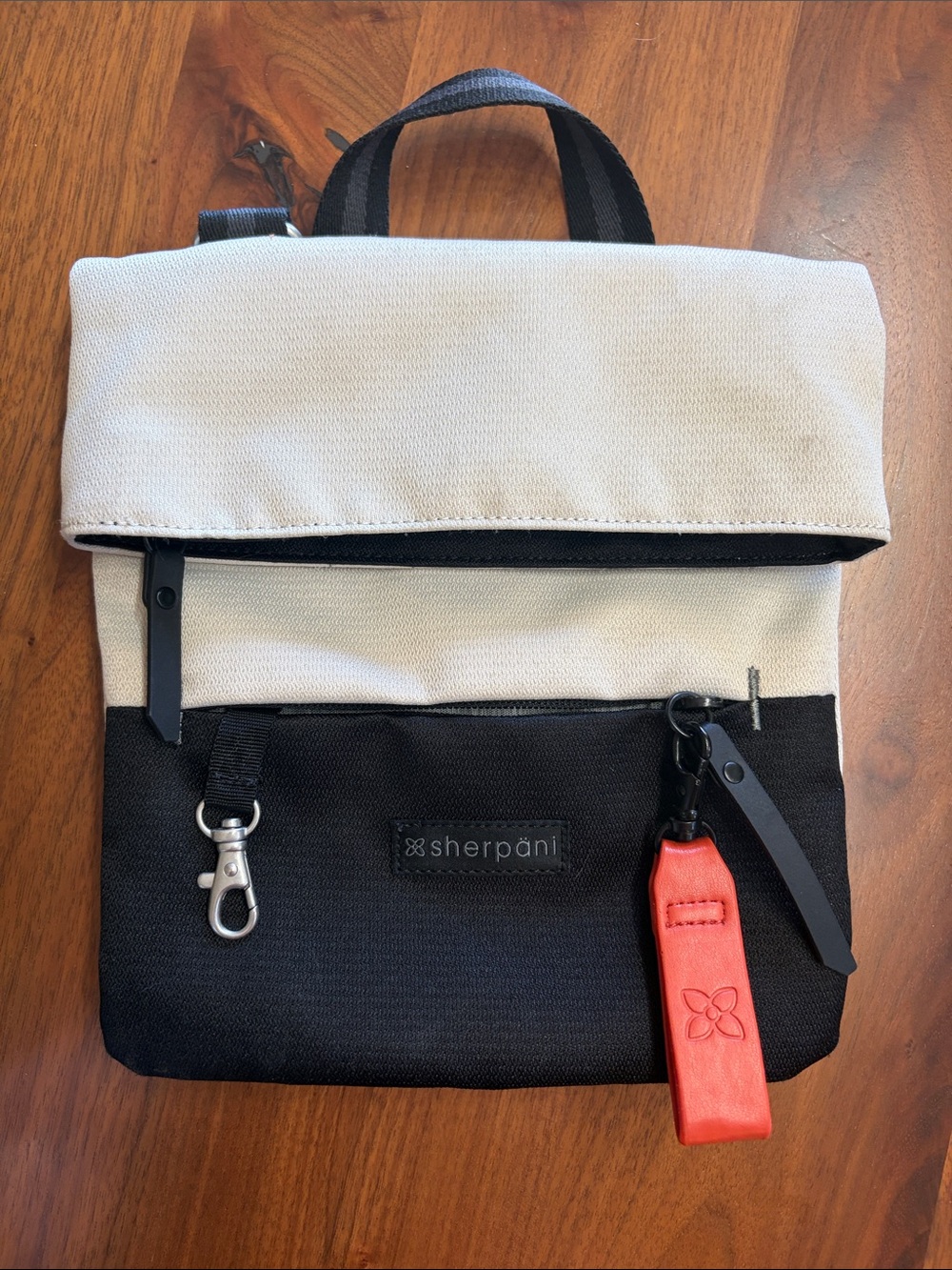 Sherpani Black & Cream Fold-Top Crossbody Backpack with Red Tag